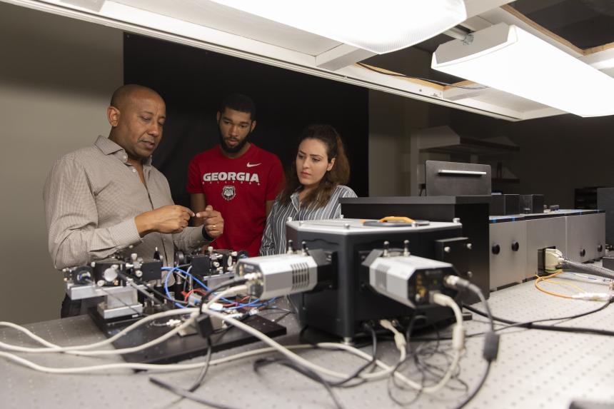  Professor Yohannes Abate and graduate students Marquez Howard and Neda Aghamiri working in the laboratory