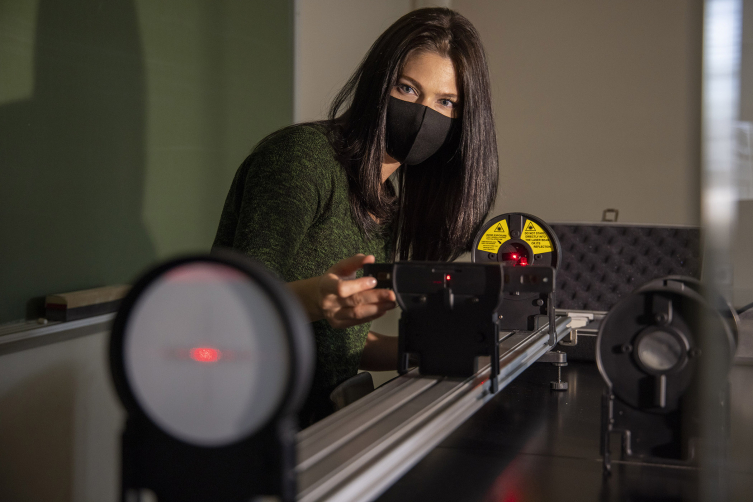 Lauren Sgro sets up a lab demo with a laser