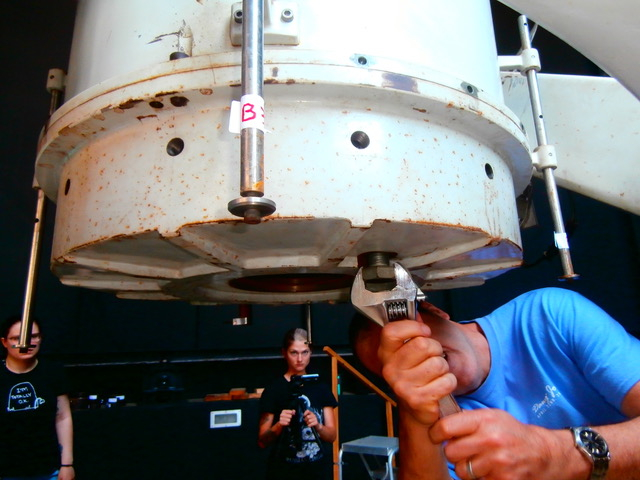 Dr. Loris Magnani is removing one of the 80 bolts that hold the telescope together, so that he, Dr. J. Scott Shaw, Dr. Robin Shelton, Tom Barnello, Lauren Sgro, and Ashton Rutkowski can remove the primary mirror.