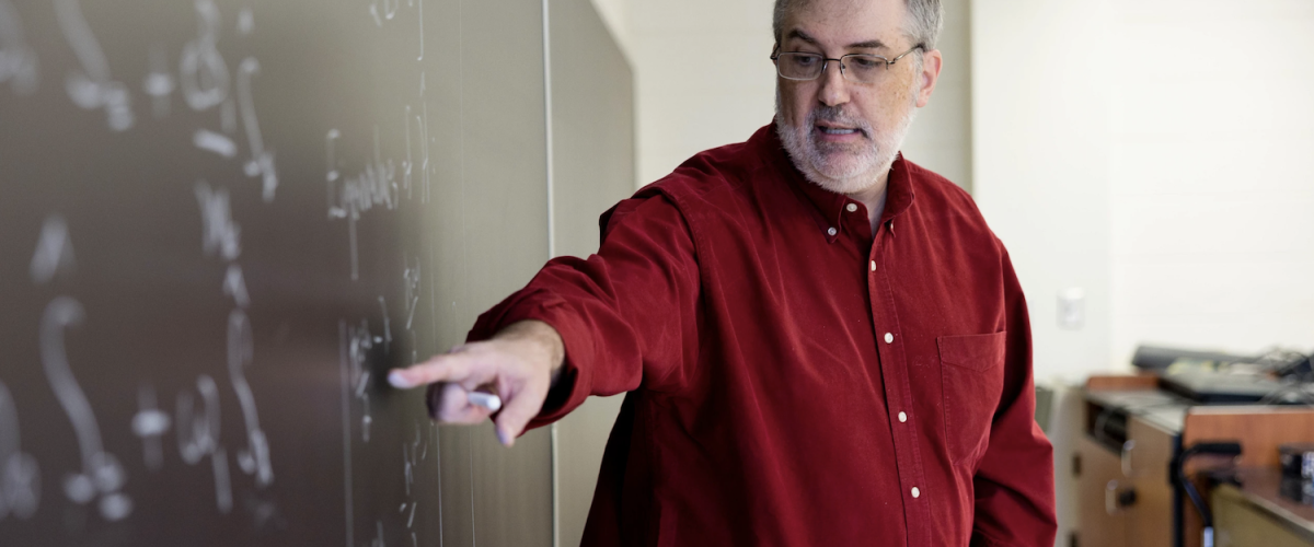 Associate professor Steven Lewis teaches his quantum mechanics physics course in a classroom in the Physics Building.